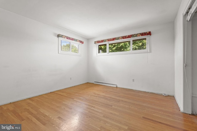 2418 Berkshire Ln, Dover, PA 17315 - empty room featuring a baseboard radiator, light wood-style floors, and baseboards