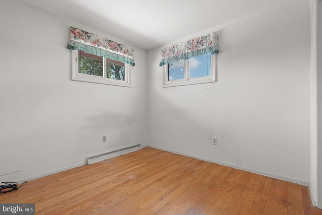 2418 Berkshire Ln, Dover, PA 17315 - spare room featuring a baseboard radiator, light wood-type flooring, and baseboards
