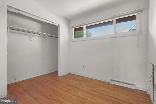 2418 Berkshire Ln, Dover, PA 17315 - unfurnished bedroom featuring baseboard heating, a closet, and wood finished floors