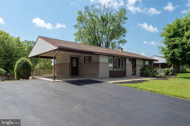 2418 Berkshire Ln, Dover, PA 17315 - ranch-style home featuring an attached carport, brick siding, driveway, a front yard, and a chimney