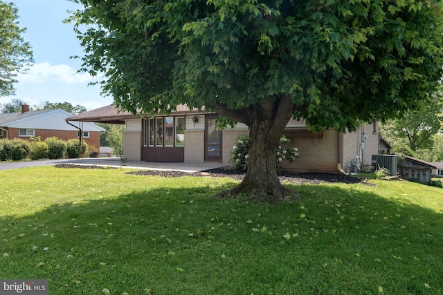 2418 Berkshire Ln, Dover, PA 17315 - view of front of home with brick siding, a front lawn, driveway, and central AC