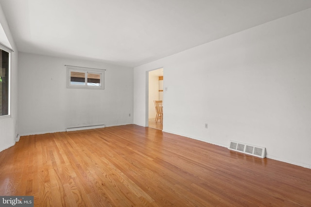 2418 Berkshire Ln, Dover, PA 17315 - empty room featuring a baseboard heating unit, light wood-style flooring, and baseboards