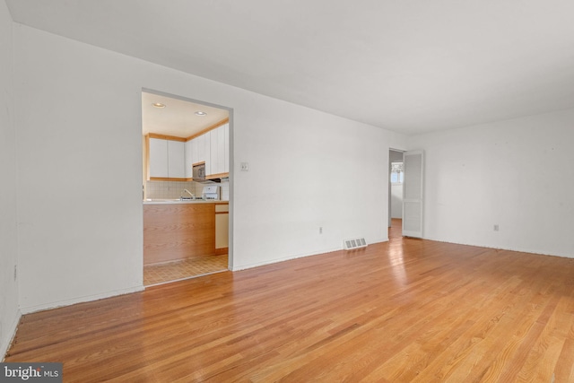2418 Berkshire Ln, Dover, PA 17315 - unfurnished living room featuring light wood-style flooring