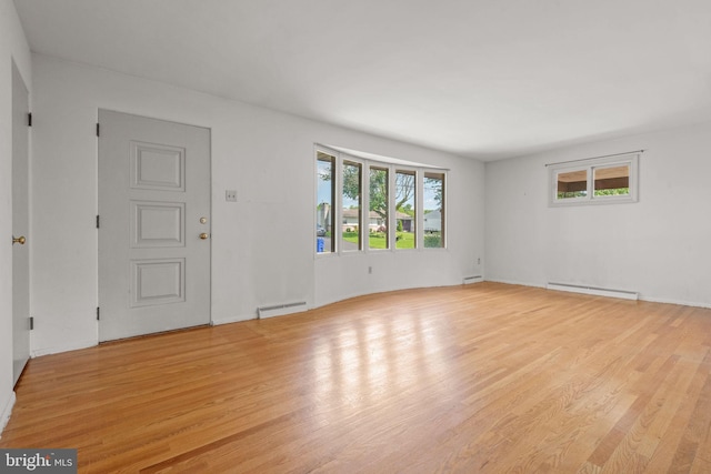 2418 Berkshire Ln, Dover, PA 17315 - unfurnished room with a baseboard heating unit, plenty of natural light, and wood finished floors