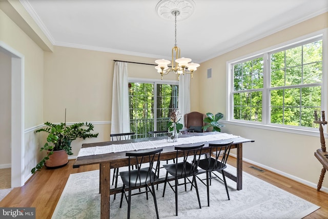 117 Graystone Farm Rd, White Hall, MD 21161 - dining area featuring a chandelier, crown molding, baseboards, and wood finished floors