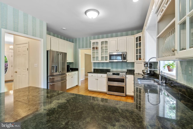 117 Graystone Farm Rd, White Hall, MD 21161 - kitchen featuring appliances with stainless steel finishes, wallpapered walls, a sink, white cabinetry, and dark stone countertops