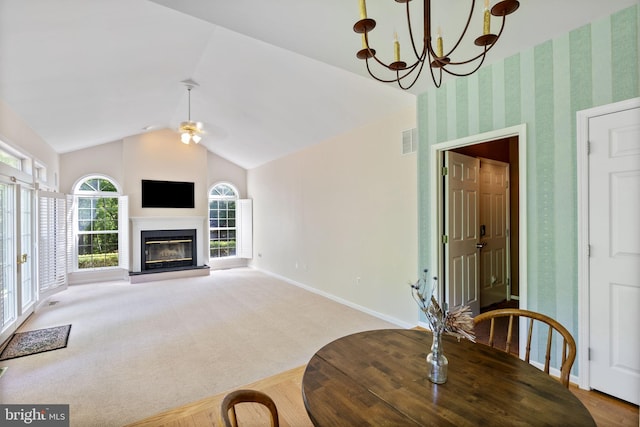 117 Graystone Farm Rd, White Hall, MD 21161 - dining space featuring lofted ceiling, baseboards, a chandelier, a glass covered fireplace, and a ceiling fan