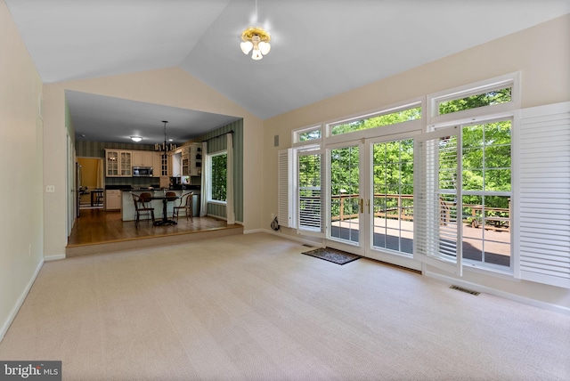 117 Graystone Farm Rd, White Hall, MD 21161 - unfurnished living room featuring light carpet, lofted ceiling, a chandelier, and baseboards