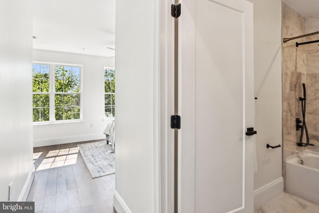 322 56th St NE, Washington, DC 20019 - full bath featuring wood finished floors, baseboards, and shower / tub combination