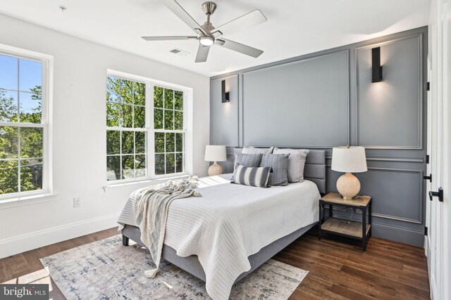 322 56th St NE, Washington, DC 20019 - bedroom featuring multiple windows, visible vents, dark wood-style flooring, and baseboards
