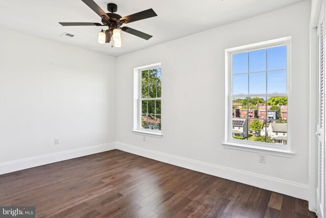 322 56th St NE, Washington, DC 20019 - empty room featuring dark wood-type flooring, baseboards, a ceiling fan, and visible vents