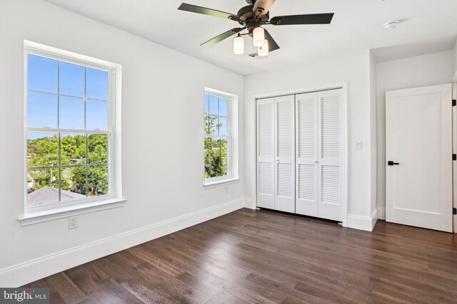322 56th St NE, Washington, DC 20019 - unfurnished bedroom featuring ceiling fan, baseboards, dark wood-type flooring, and a closet