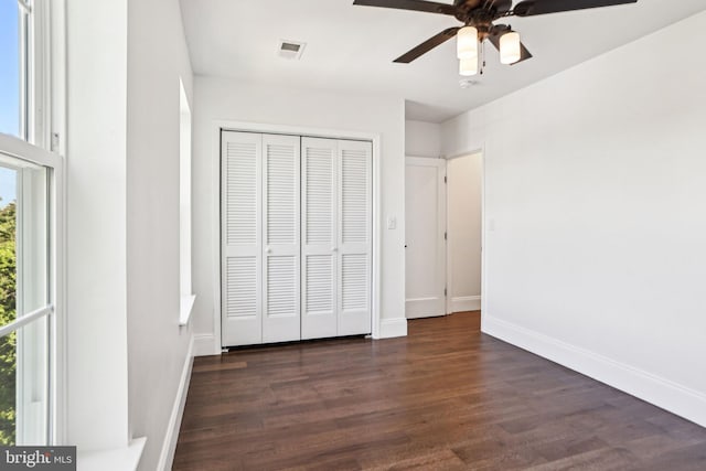 322 56th St NE, Washington, DC 20019 - unfurnished bedroom featuring baseboards, a closet, dark wood finished floors, and visible vents
