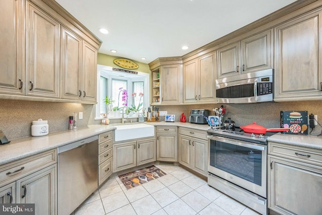 745 Germantown Pike, Lafayette Hill, PA 19444 - kitchen featuring stainless steel appliances, a sink, light tile patterned flooring, tasteful backsplash, and light countertops