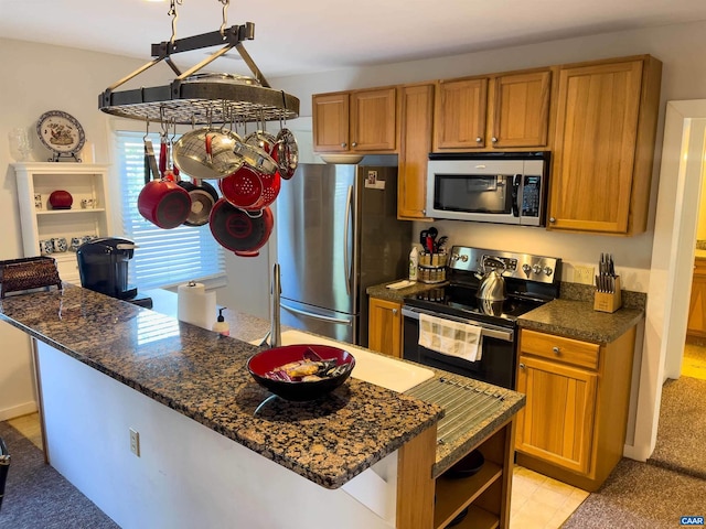 518 Meade Ave, Charlottesville, VA 22902 - kitchen with brown cabinetry, dark stone countertops, appliances with stainless steel finishes, and open shelves