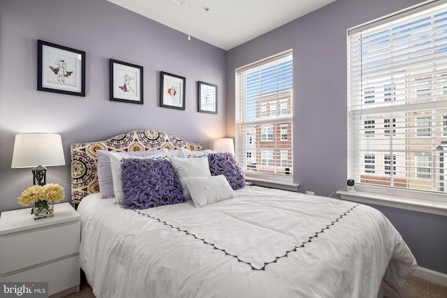 carpeted bedroom featuring baseboards