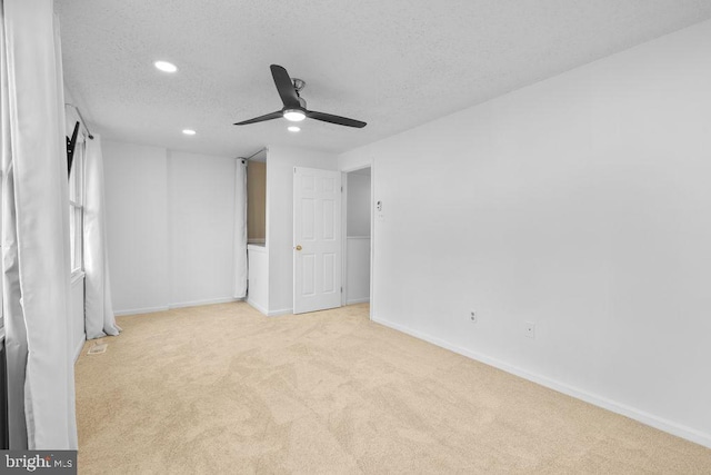 unfurnished bedroom with baseboards, carpet flooring, a textured ceiling, and recessed lighting