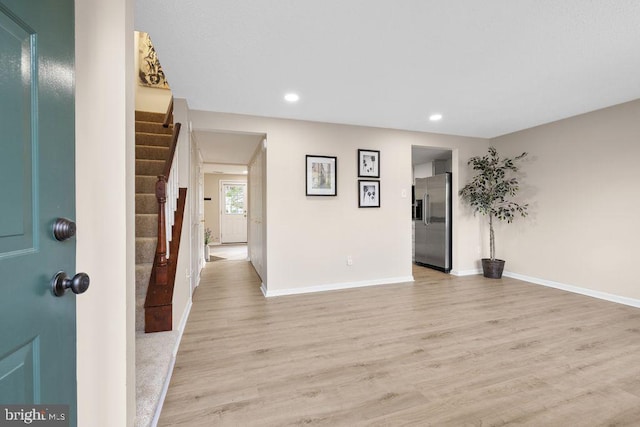 interior space with baseboards, light wood-style floors, and recessed lighting