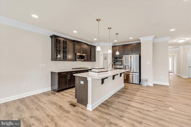 12524 Salisbury Rd, Ocean City, MD 21842 - kitchen with crown molding, appliances with stainless steel finishes, and dark brown cabinetry