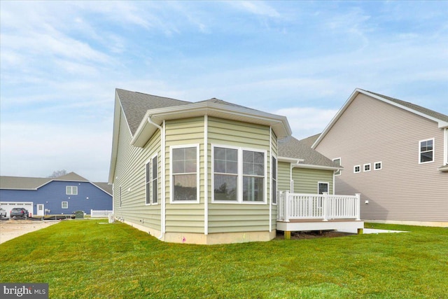 12524 Salisbury Rd, Ocean City, MD 21842 - rear view of property featuring a lawn and a deck