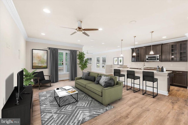 12524 Salisbury Rd, Ocean City, MD 21842 - living room featuring light wood-style flooring, crown molding, and a ceiling fan