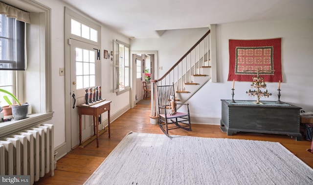 3837 Curly Hill Rd, Doylestown, PA 18902 - foyer entrance with wood finished floors, baseboards, stairs, and radiator