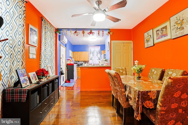 3903 N Marshall St, Philadelphia, PA 19140 - dining space featuring a ceiling fan, a wall mounted AC, and wood finished floors