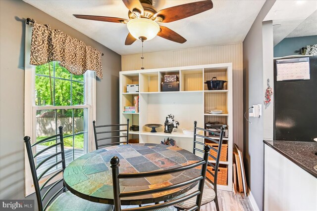 dining area featuring a ceiling fan and light wood finished floors