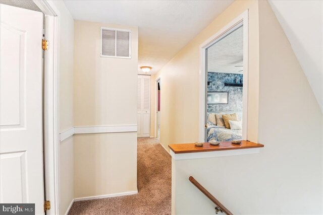corridor featuring carpet floors and visible vents