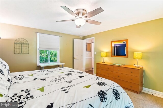 bedroom featuring baseboards, ceiling fan, and carpet flooring