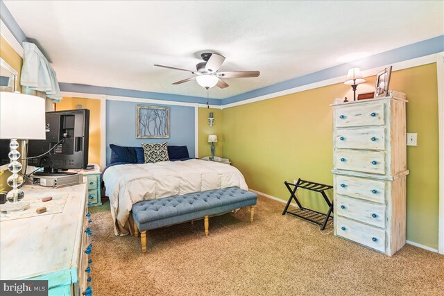 bedroom featuring baseboards, ceiling fan, and carpet flooring