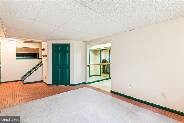 unfurnished room with stairway, baseboards, and carpet flooring
