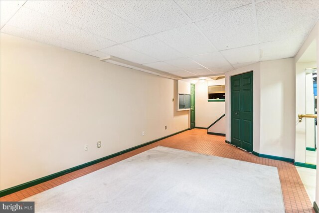 empty room with baseboards and carpet