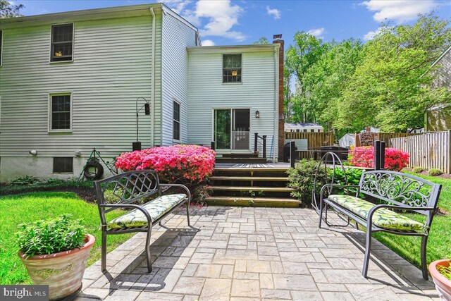 rear view of house with a patio, fence, a chimney, and a deck