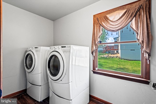 washroom with washer and clothes dryer, laundry area, baseboards, and dark wood finished floors