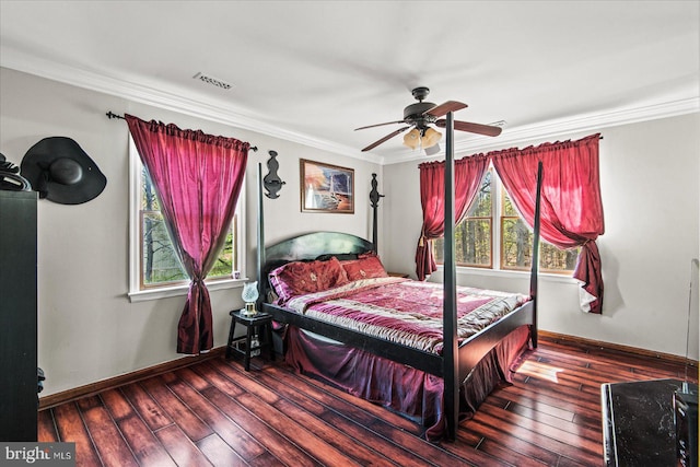 bedroom with multiple windows, visible vents, hardwood / wood-style flooring, and ornamental molding
