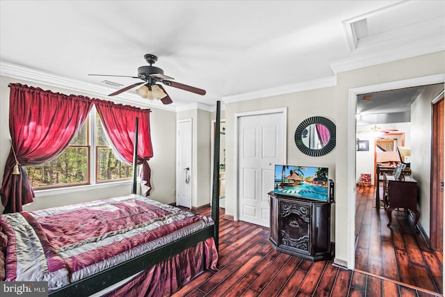 bedroom featuring crown molding, dark wood-type flooring, a ceiling fan, visible vents, and attic access