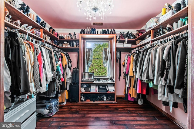 spacious closet featuring a notable chandelier and wood finished floors