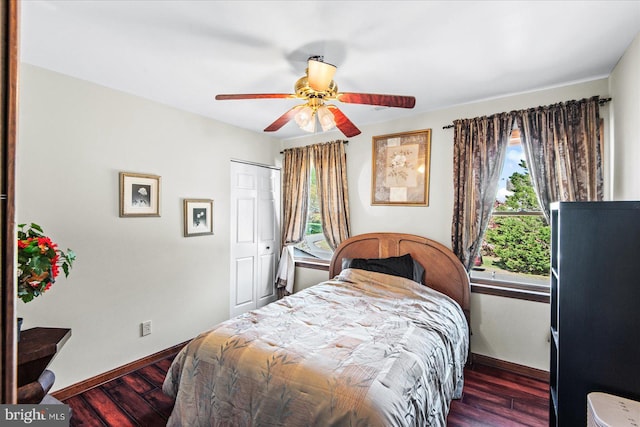 bedroom featuring a closet, baseboards, ceiling fan, and wood finished floors