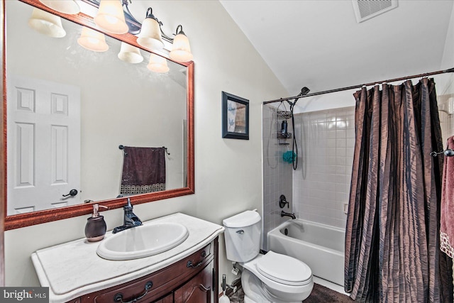 bathroom with vanity, vaulted ceiling, visible vents, toilet, and shower / bath combo