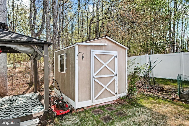 view of shed featuring fence