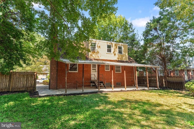 back of house with a patio area, fence, brick siding, entry steps, and a lawn