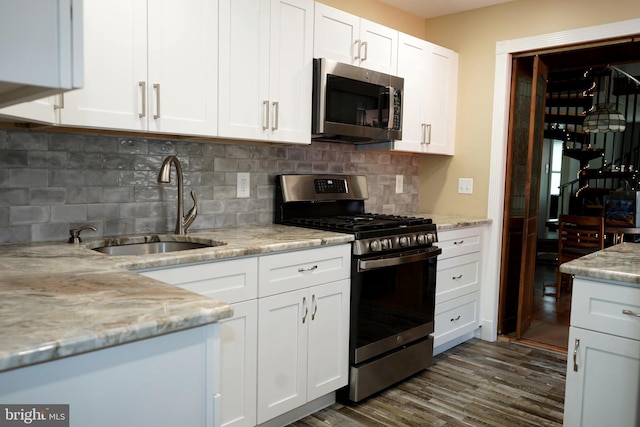 360 Haverford Ave, Wenonah, NJ 08090 - kitchen with dark wood-style flooring, a sink, stainless steel appliances, white cabinetry, and backsplash