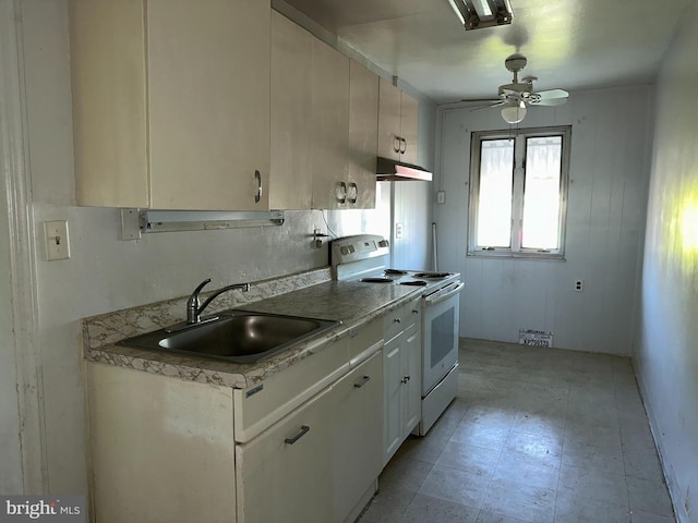 kitchen with a sink, light countertops, white range with electric cooktop, and under cabinet range hood