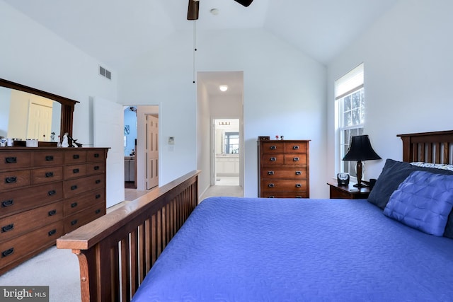 bedroom with ceiling fan, connected bathroom, light colored carpet, visible vents, and lofted ceiling