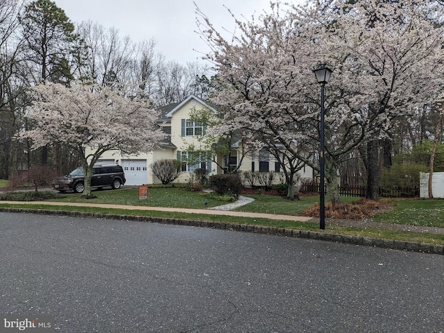 view of front of home with a garage and a front lawn
