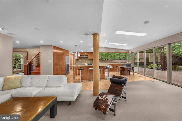 400 Highview Dr, Wayne, PA 19087 - living room with light wood finished floors, recessed lighting, a skylight, and stairs