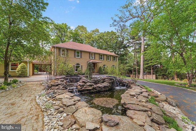 400 Highview Dr, Wayne, PA 19087 - colonial-style house featuring a small pond, driveway, a carport, and fence