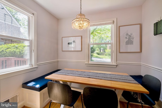 dining space with an inviting chandelier and visible vents