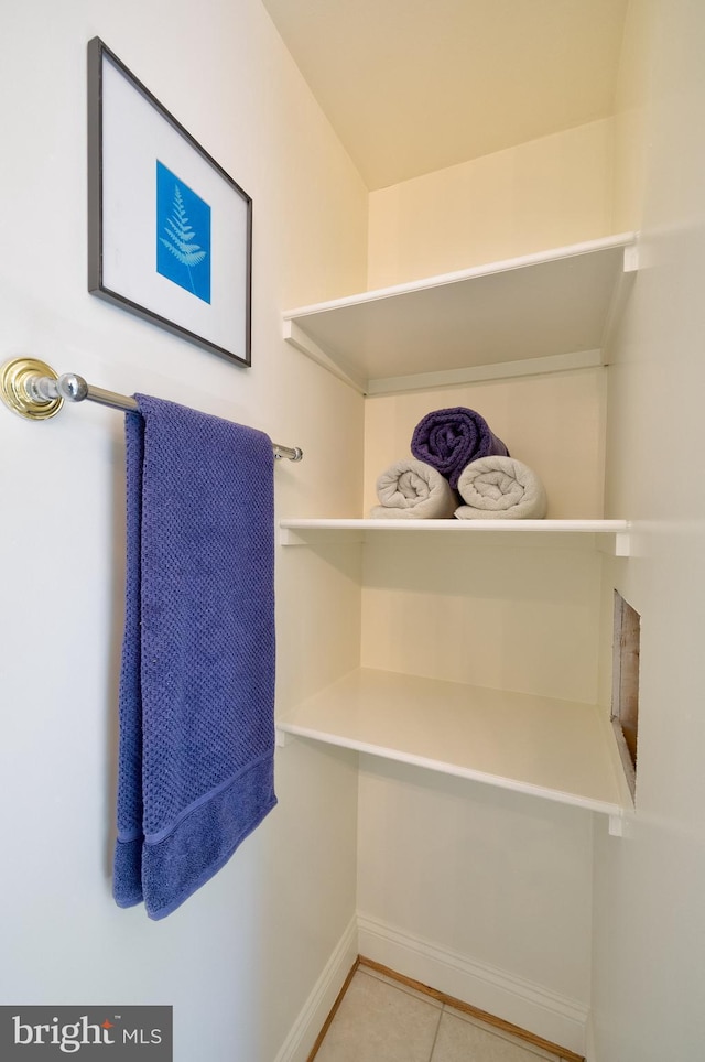 bathroom featuring baseboards and tile patterned flooring